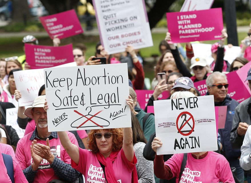 In this May 21, 2019, file photo, people gather at the state Capitol to rally in support of abortion rights in Sacramento, Calif. The Trump administration has agreed to postpone implementing a rule allowing medical workers to decline performing abortions or other treatments on moral or religious grounds while the so-called &amp;quot;conscience&amp;quot; rule is challenged in a California court. The rule was supposed to take effect on July 22, but the government and its opponents in a California lawsuit mutually agreed Friday, June 28, 2019, to delay a final ruling on the matter for four months. (AP Photo/Rich Pedroncelli, File)