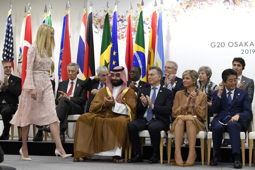 Ivanka Trump, standing, walks back to her seat following her remarks at the G-20 summit event on women's empowerment in Osaka, Japan, Saturday, June 29, 2019. Trump walks past, starting front row right, Japanese Prime Minister Shinzo Abe, Queen Maxima of the Netherlands, Argentine President Mauricio Macri, and Saudi Prince Mohammed bin Salman. (AP Photo/Susan Walsh)