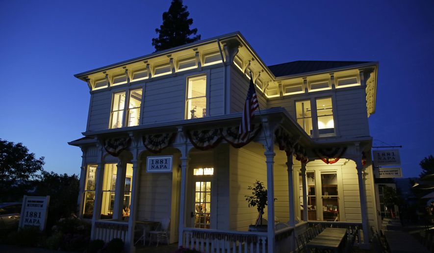 In this photo taken Wednesday, June 5, 2019, dusk falls on 1881 Napa in Oakville, Calif. 1881 Napa, a wine history museum and tasting salon, opened this month in Oakville, about 60 miles (97 kilometers) north of San Francisco. It offers self-guided tours on Napa Valley's history and early pioneers, along with a collection of rare winemaking tools such as scalders, filters, spigots and soil injectors. (AP Photo/Eric Risberg)