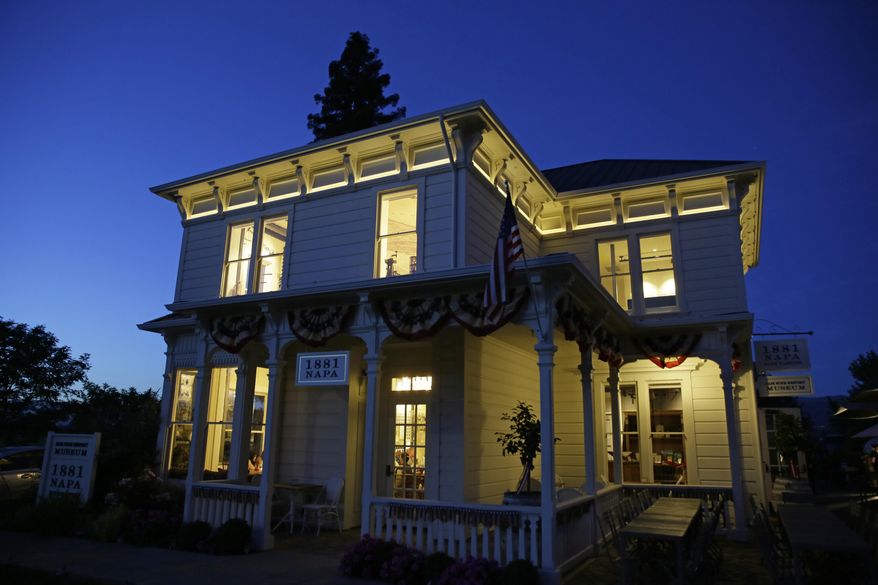 In this photo taken Wednesday, June 5, 2019, dusk falls on 1881 Napa in Oakville, Calif. 1881 Napa, a wine history museum and tasting salon, opened this month in Oakville, about 60 miles (97 kilometers) north of San Francisco. It offers self-guided tours on Napa Valley's history and early pioneers, along with a collection of rare winemaking tools such as scalders, filters, spigots and soil injectors. (AP Photo/Eric Risberg)