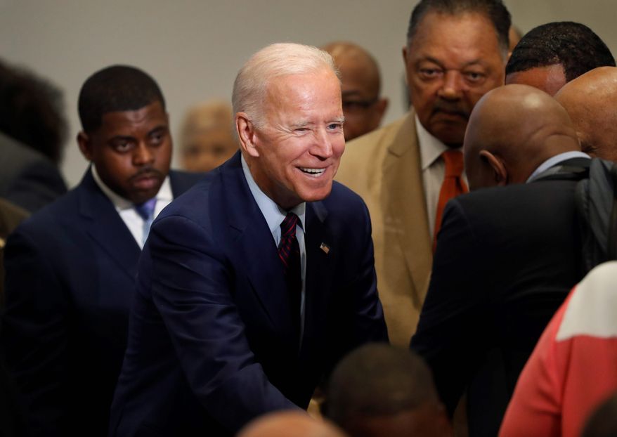 Democratic presidential candidate former Vice President Joe Biden greets people in the audience before addressing the Rainbow PUSH Coalition Annual International Convention Friday, June 28, 2019, in Chicago. (AP Photo/Charles Rex Arbogast)
