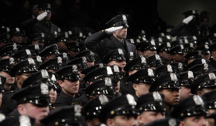 New York Police Department recruits salute as a medley of armed forces anthems is played during graduation ceremonies in New York's Madison Square Garden, Thursday, Dec. 22, 2011. Mayor Michael Bloomberg and Police Commissioner Raymond Kelly presided over the graduation ceremony Thursday for 1,519 new police officers. The graduates have completed more than six months of training at New York City's Police Academy. (AP Photo/Richard Drew)