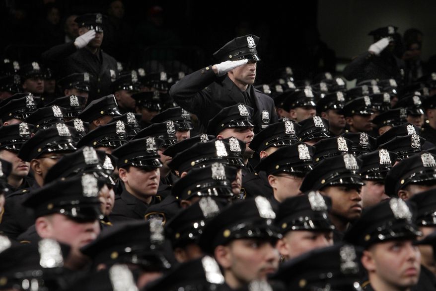 New York Police Department recruits salute as a medley of armed forces anthems is played during graduation ceremonies in New York's Madison Square Garden, Thursday, Dec. 22, 2011. Mayor Michael Bloomberg and Police Commissioner Raymond Kelly presided over the graduation ceremony Thursday for 1,519 new police officers. The graduates have completed more than six months of training at New York City's Police Academy. (AP Photo/Richard Drew)
