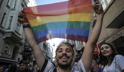 An activist brandishes a rainbow flag as Turkey&#39;s lesbian, gay, bisexual, trans and intersex activists march despite a ban, in Istanbul, Sunday, July 1, 2018.  The Istanbul LGBTI+ activists gathered in the city&#39;s Taksim neighbourhood after they announced Istanbul&#39;s local government had banned the Pride march for the fourth year in a row. (AP Photo/Emrah Gurel)