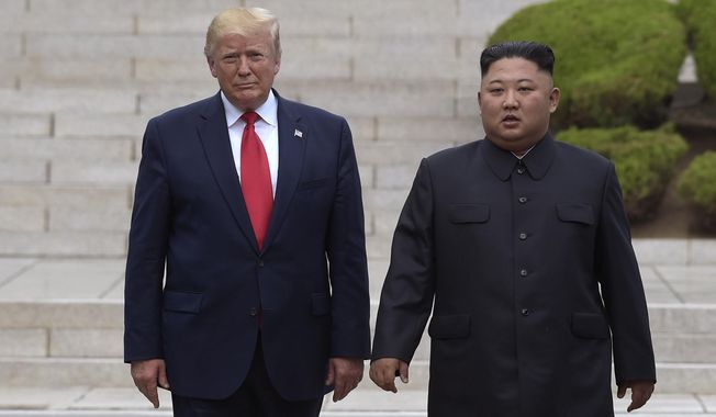 President Donald Trump, left, meets with North Korean leader Kim Jong Un at the North Korean side of the border at the village of Panmunjom in Demilitarized Zone, Sunday, June 30, 2019. (AP Photo/Susan Walsh)