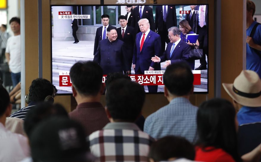 People in Seoul watched a TV screen Sunday showing President Trump, North Korean leader Kim Jong-un and South Korean President Moon Jae-in at the border villages of Panmunjom. (Associated Press)