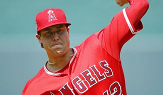 In this June 25, 2018 file photo Los Angeles Angels starting pitcher Tyler Skaggs throws during the first inning of a baseball game against the Kansas City Royals in Kansas City, Mo. Tyler Skaggs has died at age 27, Monday, July 1, 2019. Skaggs started the Angels&#39; game Saturday night against the Athletics. Their game against the Texas Rangers on Monday night has been postponed. (AP Photo/Charlie Riedel, file)