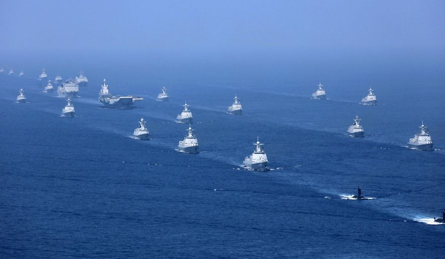 FILE - In this April 12, 2018, file photo released by Xinhua News Agency, the Liaoning aircraft carrier is accompanied by navy frigates and submarines conducting an exercises in the South China Sea. China’s navy, coast guard and maritime militia are a constant presence in the region and it staged a massive fleet review in the area last year featuring its sole operating aircraft carrier, the Liaoning. (Li Gang/Xinhua via AP, File)