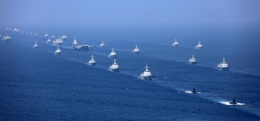 FILE - In this April 12, 2018, file photo released by Xinhua News Agency, the Liaoning aircraft carrier is accompanied by navy frigates and submarines conducting an exercises in the South China Sea. China’s navy, coast guard and maritime militia are a constant presence in the region and it staged a massive fleet review in the area last year featuring its sole operating aircraft carrier, the Liaoning. (Li Gang/Xinhua via AP, File)