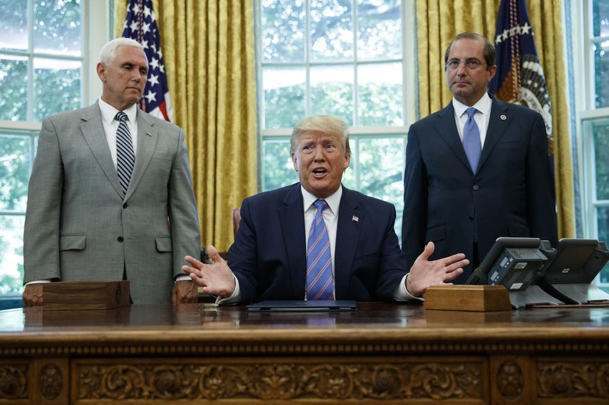 President Donald Trump, joined by Vice President Mike Pence, left, and Secretary of Health and Human Services Alex Azar, right, speaks during a signing ceremony in the Oval Office of the White House in Washington, Monday, July 1, 2019. (AP Photo/Carolyn Kaster)