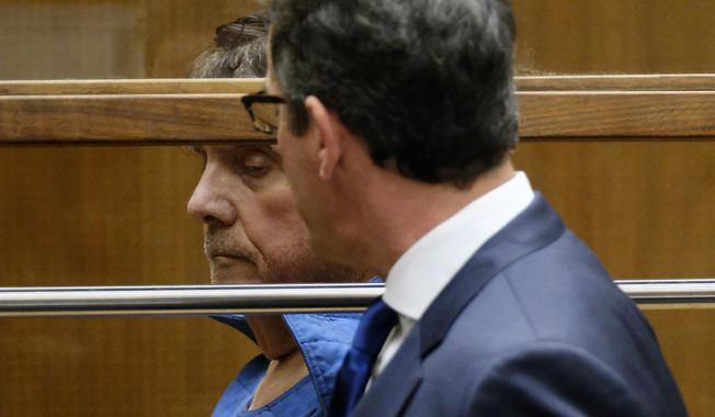 Dr. George Tyndall, 72, confers with his attorney Andrew Flier during an arraignment at Los Angeles Superior court, Monday, July 1, 12019, in Los Angeles. The former longtime gynecologist at the University of Southern California is charged with sexually assaulting 16 women at the student health center. (AP Photo/Richard Vogel)