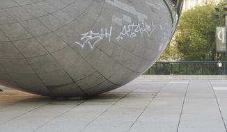 Graffiti mars the popular giant metallic sculpture known as &amp;quot;The Bean,&amp;quot; Tuesday, July 2, 2019, in Chicago. Police in Chicago have arrested seven people suspected of spray-painting graffiti on two downtown landmarks, including the popular giant metallic sculpture known as &amp;quot;The Bean.&amp;quot; (Jermaine Nolen/Chicago Sun-Times via AP)