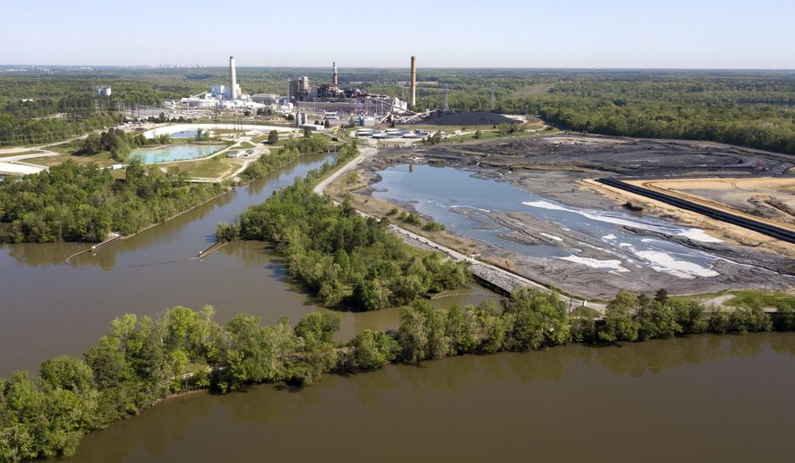 FILE - In this May 1, 2018 file photo the Richmond city skyline can be seen on the horizon behind the coal ash ponds along the James River near Dominion Energy's Chesterfield Power Station in Chester, Va. U.S. EPA officials said Tuesday, July 2, 2019, that modern industry practices and recently-enacted regulations are sufficient to shield taxpayers from potential cleanup costs. (AP Photo/Steve Helber, File)