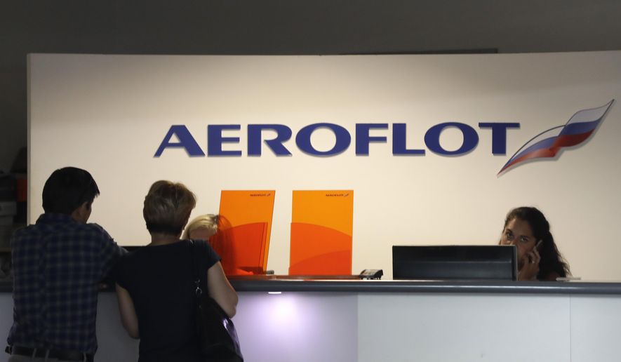 Customers stand by a counter as some of the flights of Russian airline Aeroflot were canceled at the airport in Prague, Czech Republic, Tuesday, July 2, 2019. (AP Photo/Petr David Josek) ** FILE **