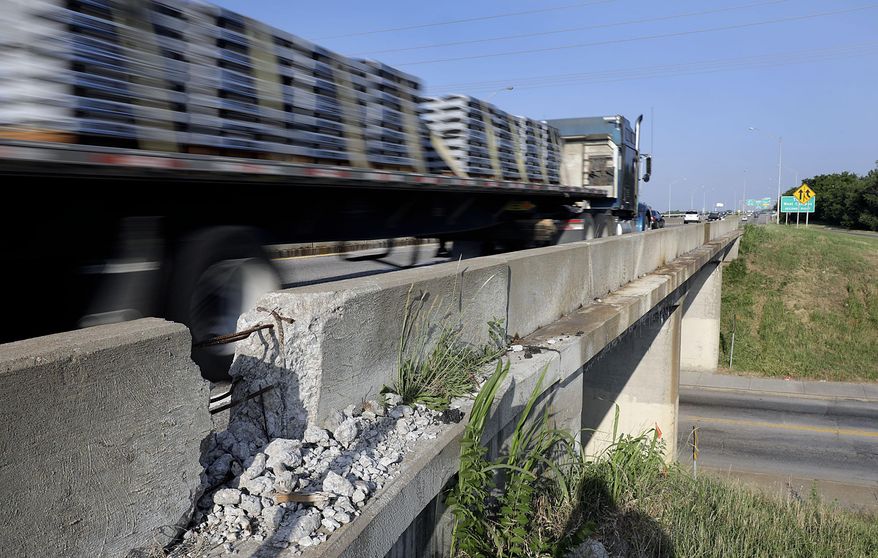 In this June 6, 2018 photo, traffic traffic along Interstate 44 crosses an overpass at S. 33rd West Ave. in Tulsa, Okla. Officials said Monday, July 1, 2019, that the number of structurally deficient bridges in Oklahoma has dropped from about 1,170 in 2004 to 132. (Mike Simons/Tulsa World via AP)
