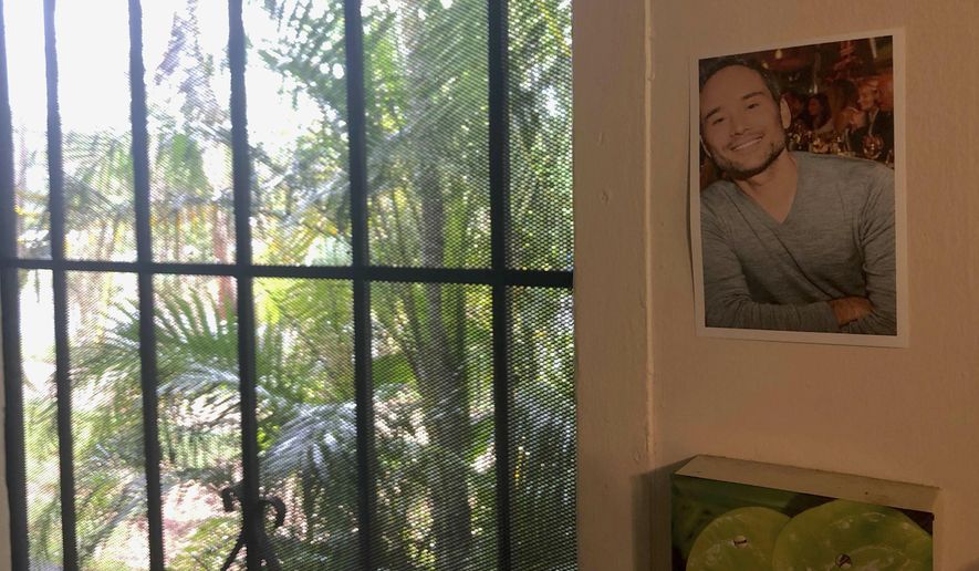 In this Friday, June 28, 2019 photo, a photograph of pilot Jerome Renck hangs next to the door of his apartment in Waialua, Hawaii. The Honolulu Medical Examiner has identified the last two victims of a deadly plane crash on Oahu's North Shore that killed 11 people. In a release Tuesday, July 2, 2019, officials identified the victims as 42-year-old Jerome Renck and 48-year-old James Lisenbee, both of Hawaii. (AP Photo/Caleb Jones)