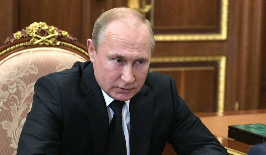 Russian President Vladimir Putin listens to Russian Defense Minister Sergei Shoigu during their meeting in the Kremlin in Moscow, Russia, Tuesday, July 2, 2019. A fire on one of the Russian navy&#39;s deep-sea submersibles killed 14 sailors, the Russian Defense Ministry said Tuesday without giving the cause of the blaze or saying if there were survivors. (Alexei Druzhinin, Sputnik, Kremlin Pool Photo via AP)