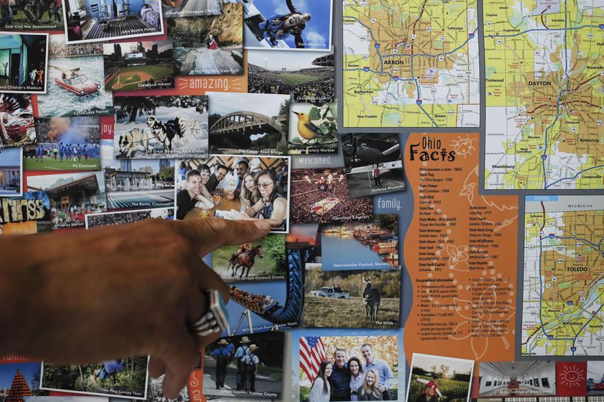 In this June 6, 2019, photo, Bruce Hull points to an image of his daughter on a state map as he is interviewed at his offices at the Ohio Department of Transportation in Columbus. If your summer travel plans involve traversing Ohio and you're still a fan of paper maps, it's time you meet Bruce Hull. As a layout design artist with the Ohio Department of Transportation since 1989, the 60-year-old Hull has creative control over the map's look and feel, from the graphics to the paper to the fold that's used. (AP Photo/John Minchillo)