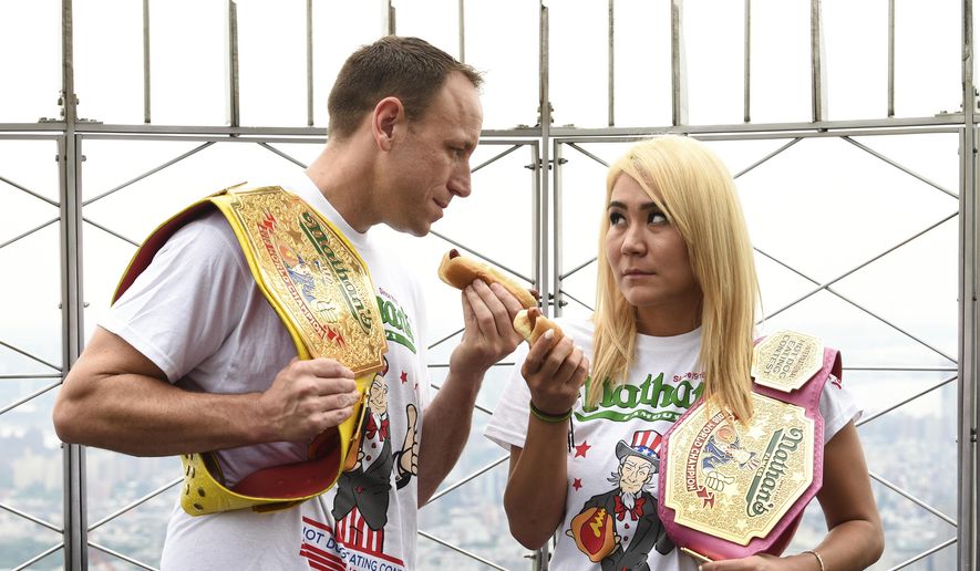 Eleven-time and defending men&#x27;s champion Joey Chestnut, left, and defending women&#x27;s champion Miki Sudo pose together during Nathan&#x27;s Famous international Fourth of July hot dog eating contest weigh-in at the Empire State Building on Wednesday, July 3, 2019, in New York. (Photo by Evan Agostini/Invision/AP)