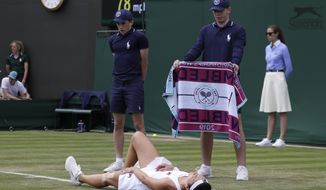 Russia&#39;s Margarita Gasparyan lays injured on the court against Ukraine&#39;s Elina Svitolina in a Women&#39;s singles match during day three of the Wimbledon Tennis Championships in London, Wednesday, July 3, 2019. (AP Photo/Kirsty Wigglesworth)