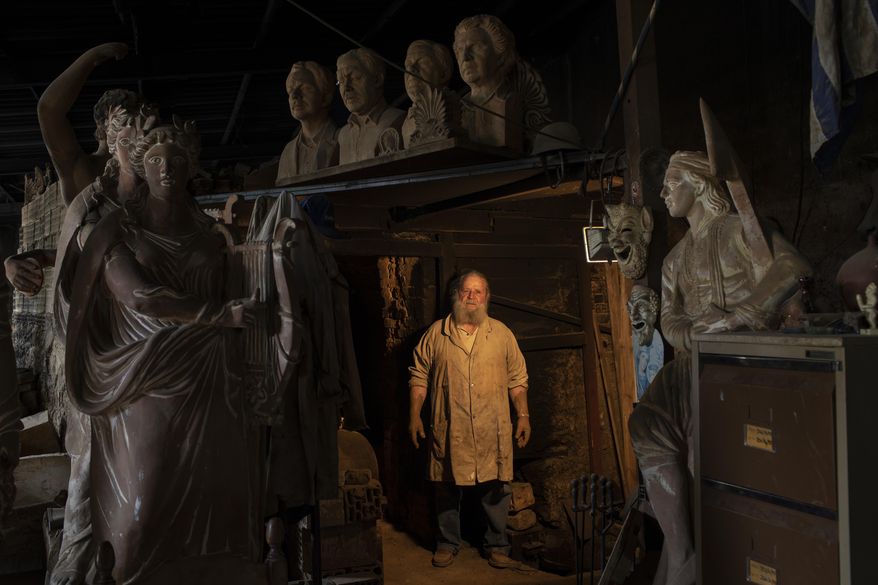 In this Wednesday, June 12, 2019 photo, Haralambos Goumas, a 69-year-old sculptor and ceramicist poses for a photo and answers questions about his expectations of the new government, inside his workshop in Athens. He says: "I've had a hard time over the past decade with all the austerity measures foisted on us. Even though I've reached a pensionable age I continue to work, but again I could only expect a very modest pension. I hope that one day my workshop will fill up with young artists so I can teach them ceramics and sculpture ... But to do that I will need help from the government, which unfortunately doesn't look as if it will be forthcoming. Nevertheless, I am an optimist and believe Greece will progress." (AP Photo/Petros Giannakouris)