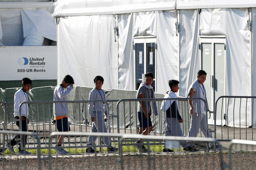 In this Feb.19, 2019, file photo, children line up to enter a tent at the Homestead Temporary Shelter for Unaccompanied Children in Homestead, Fla. (AP Photo/Wilfredo Lee, File)