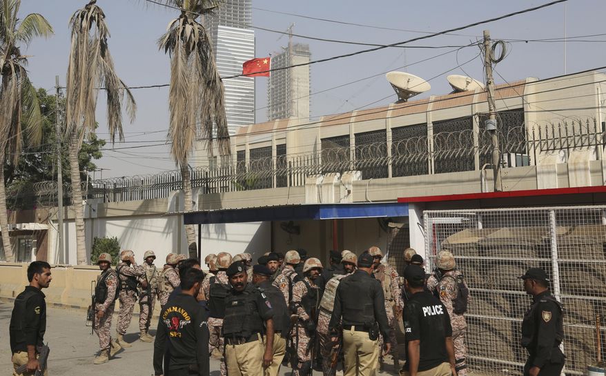 FILE - In this Nov. 23, 2018, file photo, Pakistani security personnel move in the compound of Chinese Consulate following an attack in Karachi, Pakistan. The United States has declared Pakistan's separatist Baluchistan Liberation Army organization a terrorist group and says it will seek to deny it resources for planning and carrying out attacks. The group targeted Chinese engineers in Baluchistan and attacked on the Chinese Consulate in Karachi. (AP Photo/Shakil Adil, File)