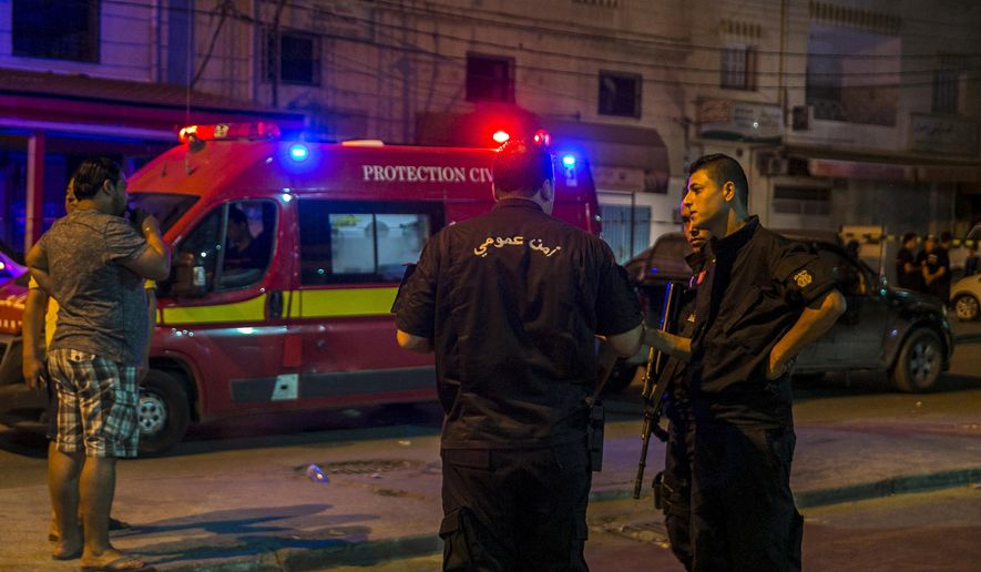 Tunisian police officers stand guard after police shot at a man wanted for terrorism in Al Intilaka, near Tunis, Tunisia Tuesday, July 2, 2019. Police shot at a man wanted for terrorism during a confrontation late Tuesday in Tunisia's capital and the suspect was killed when his explosive belt detonated, the Interior Ministry said. (AP Photo/Riadh Dridi)