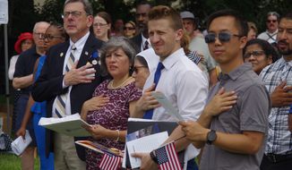 Fifty-one foreign nationals from 28 countries take the Oath of Allegiance to become U.S. citizens on Thursday at Mount Vernon. (Moss Brennan/The Washington Times)