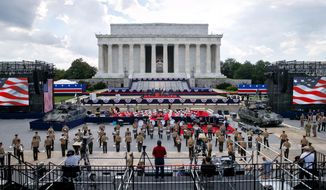 Two Bradley Fighting Vehicles flank the stage being prepared in front of the Lincoln Memorial, Wednesday, July 3, 2019, in Washington, ahead of planned Fourth of July festivities with President Donald Trump. (AP Photo/Jacquelyn Martin)