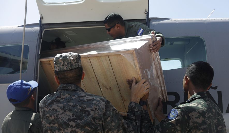 An empty coffin is loaded on to a plane to fly to the site of a fishing boat accident, from a military airport in Tegucigalpa, Honduras, Thursday, July 4, 2019. A fishing vessel sank during bad weather Wednesday near Cayo Gorda in the Caribbean off Honduras’ northern coast. (AP Photo/Elmer Martinez)