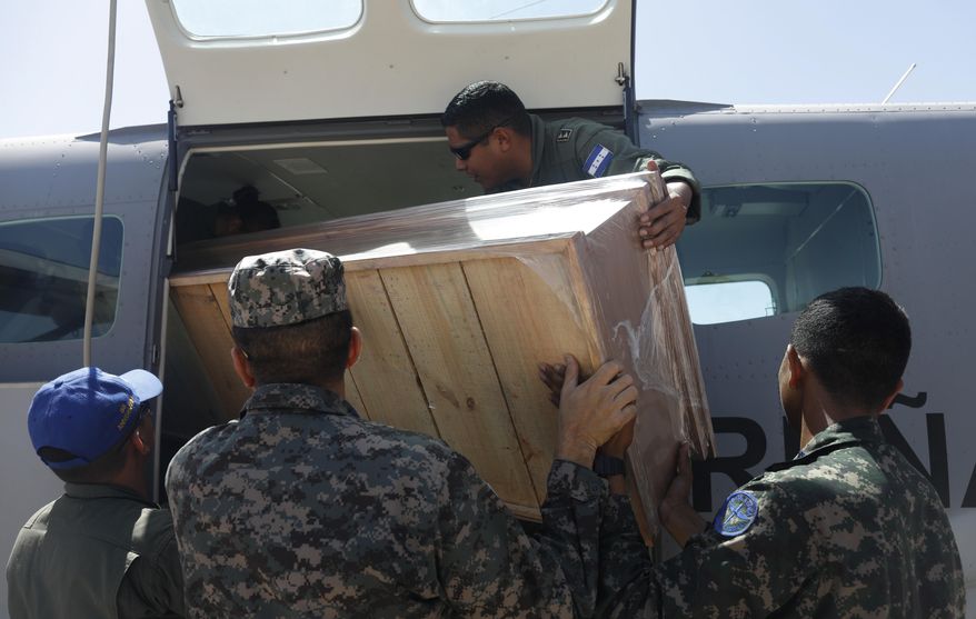 An empty coffin is loaded on to a plane to fly to the site of a fishing boat accident, from a military airport in Tegucigalpa, Honduras, Thursday, July 4, 2019. A fishing vessel sank during bad weather Wednesday near Cayo Gorda in the Caribbean off Honduras’ northern coast. (AP Photo/Elmer Martinez)