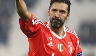 FILE - In this Nov. 22, 2017 file photo, Juventus goalkeeper Gianluigi Buffon gives the v-sign to fans at the end of the Champions League group D soccer match between Juventus and Barcelona, at the Allianz Stadium in Turin, Italy.  The longtime Bianconeri goalkeeper was undergoing medical tests with Juventus on Thursday, July 4, 2019, after which he was expected to sign a one-year contract with the club after being away at Paris Saint-Germain for one season. (AP Photo/Antonio Calanni, file)