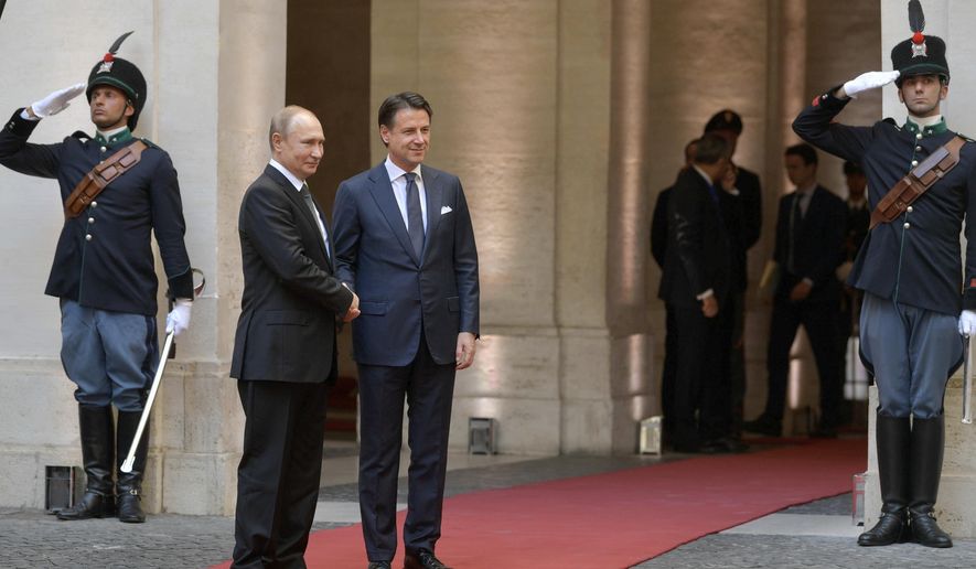 Russian President Vladimir Putin is welcomed at the Chigi palace by Italian Premier Giuseppe Conte, in Rome, Thursday, July 4, 2019. Putin emphasized historically strong ties with Italy during a one-day visit to Rome that included a meeting with Pope Francis. (Alexei Druzhinin, Sputnik, Kremlin Pool Photo via AP)