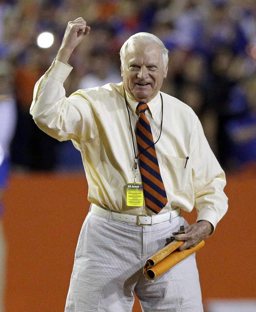 FILW - In this Nov. 26, 2011, file photo, George Edmondson Jr., known to the University of Florida community as "Mr. Two Bits," leads a cheer on the field before the first half of an NCAA college football game in Gainesville, Fla. The University of Florida's most famous cheerleader has died at age 97. The school announced Edmondson Jr.’s death two days after his passing. Edmondson was better known as "Mr. Two Bits" while riling up crowds at Florida home games for nearly 60 years. (AP Photo/John Raoux, File)