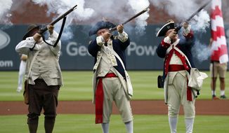 Members of a Revolutionary War re-enactment group fire a 13-gun salute during Independence Day festivities before a baseball game between the Philadelphia Phillies and the Atlanta Braves on Thursday, July 4, 2019, in Atlanta. (AP Photo/John Bazemore)