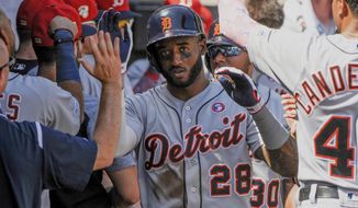 Detroit Tigers celebrate a two-run home run by Detroit Tigers Niko Goodrum (28) against the Chicago White Sox during the sixth inning of a baseball game Thursday, July 4, 2019, in Chicago. (AP Photo/Mark Black)