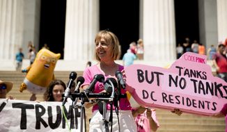 U.S. activist Medea Benjamin, co-founder of the anti-war group Code Pink, holds a sign that reads &amp;quot;Tanks But No Tanks DC Residents as she speaks at a news conference in front of the Lincoln Memorial near where workers set up for President Donald Trump&#39;s &#39;Salute to America&#39; event honoring service branches on Independence Day, Wednesday, July 3, 2019, in Washington. The group is upset by restrictions against flying their &amp;quot;Trump Baby&amp;quot; balloon tomorrow. (AP Photo/Andrew Harnik) **FILE**