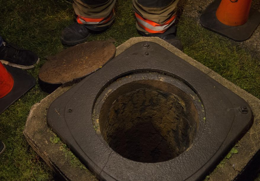 This Thursday, July 4, 2019 photo shows the storm drain where a 5-year-old boy was successfully rescued after falling approximately 27 feet in Evansville, Ind. First responders said the drain was approximately 27 feet deep and did have water in it. However, the child, who was said to be about five years old, never lost consciousness while in the drain and was able to talk. (MaCabe Brown /Evansville Courier & Press via AP)