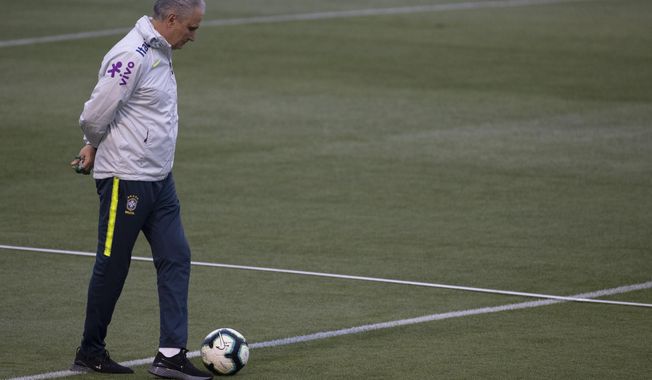 Brazil&#x27;s coach Tite walks on the field during a practice session at the Granja Comary training center in Teresopolis, Brazil, Thursday, July 4, 2019. Brazil will play against Peru for the final of the Copa America on July 7. (AP Photo/Leo Correa)