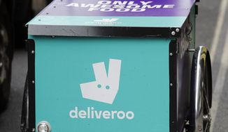 FILE - In this file photo dated Tuesday, July 11, 2017, a Deliveroo logo on a bicycle in London.  The U.K. competition watchdog has launched an investigation into Amazon’s purchase of a significant stake in food delivery service Deliveroo on Friday July 5, 2019, as the regulator is taking a more activist role in seeking to protect consumers in the evolving marketplace. (AP Photo/Frank Augstein, FILE)