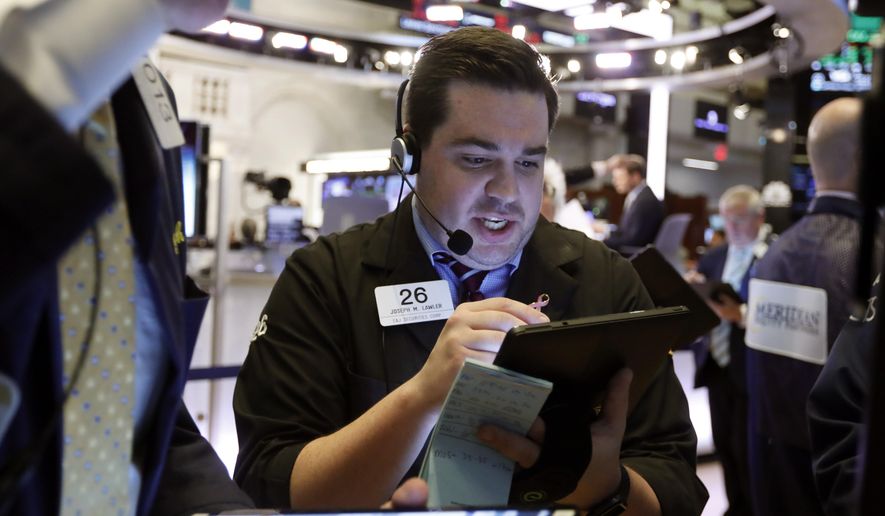 FILE - In this July 1, 2019, file photo trader Joseph Lawler works on the floor of the New York Stock Exchange. The U.S. stock market opens at 9:30 a.m. EDT on Friday, July 5. (AP Photo/Richard Drew, File)