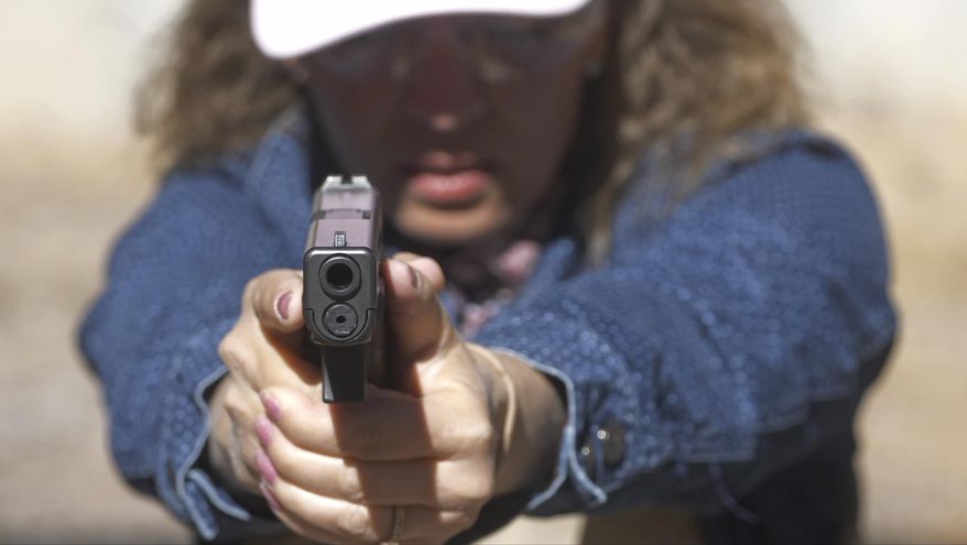 In this Saturday, June 29, 2019, photo, Cindy Bullock, Timpanogos Academy secretary, participates in shooting drills at the Utah County Sheriff's Office shooting range during the teacher's academy training, in Spanish Fork Canyon, Utah. About 30 teachers in Utah are spending their summer learning how to stuff wounds and shoot guns as part of a training held by police to prepare educators for an active shooter scenario in their schools. (AP Photo/ Rick Bowmer)