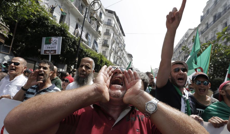 Algerian demonstrators take to the streets in the capital Algiers to protest against the government, in Algeria, Friday, July 5, 2019. Algerians are demanding new democratic leadership and celebrating their country's hard-fought independence from colonial France. (AP Photo/Toufik Doudou)