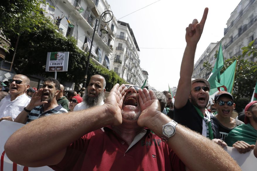 Algerian demonstrators take to the streets in the capital Algiers to protest against the government, in Algeria, Friday, July 5, 2019. Algerians are demanding new democratic leadership and celebrating their country's hard-fought independence from colonial France. (AP Photo/Toufik Doudou)