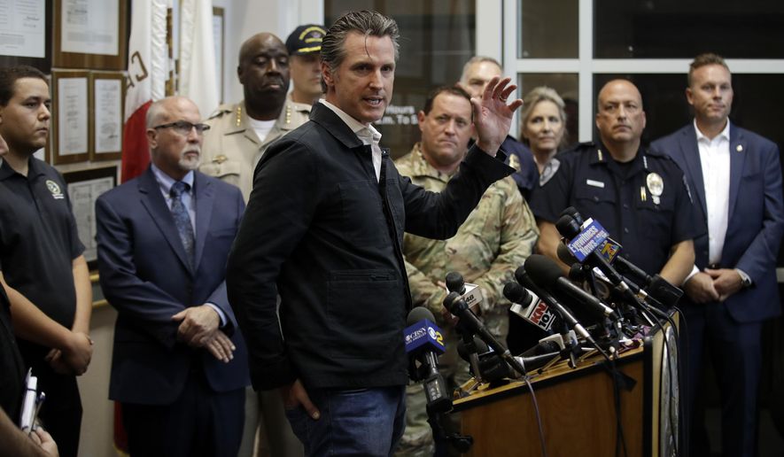California Gov. Gavin Newsom, at podium, makes a statement after touring the town Saturday, July 6, 2019, in Ridgecrest, Calif. Crews in Southern California assessed damage to cracked and burned buildings, broken roads, leaking water and gas lines and other infrastructure Saturday after the largest earthquake the region has seen in nearly 20 years jolted an area from Sacramento to Las Vegas to Mexico. (AP Photo/Marcio Jose Sanchez)