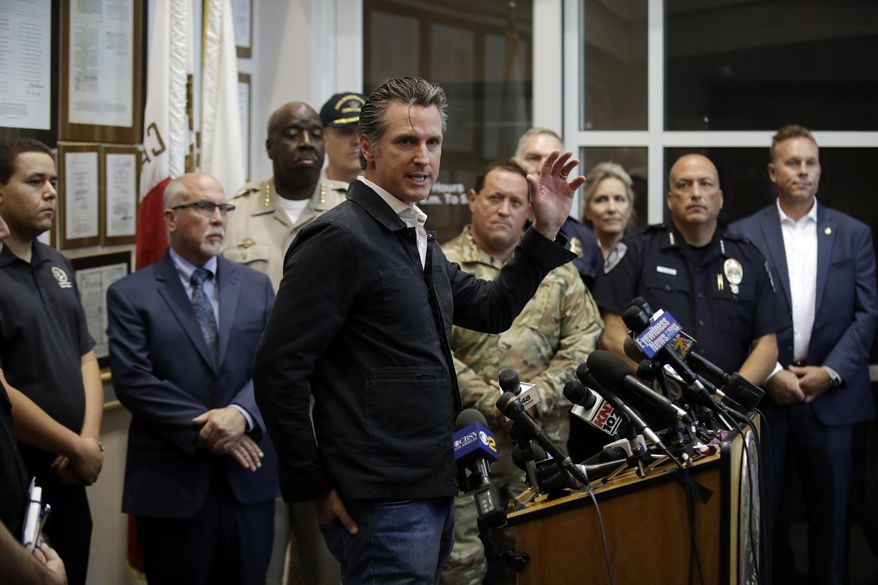 California Gov. Gavin Newsom, at podium, makes a statement after touring the town Saturday, July 6, 2019, in Ridgecrest, Calif. Crews in Southern California assessed damage to cracked and burned buildings, broken roads, leaking water and gas lines and other infrastructure Saturday after the largest earthquake the region has seen in nearly 20 years jolted an area from Sacramento to Las Vegas to Mexico. (AP Photo/Marcio Jose Sanchez)