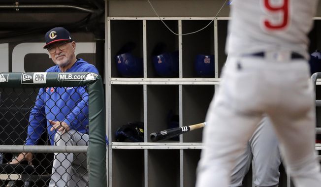 Chicago Cubs manager Joe Maddon watches Javier Baez during the first inning of the team&#x27;s baseball game against the Chicago White Sox in Chicago, Saturday, July 6, 2019. (AP Photo/Nam Y. Huh)