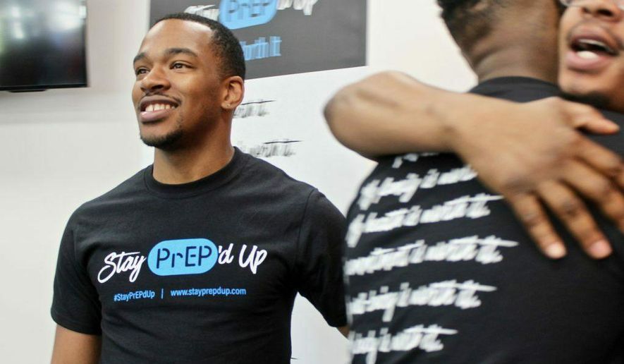 In this 2019 photo, Kenneth Wade, left, is one of the brand ambassadors for a new awareness campaign launched by the AIDS Resource Center of Wisconsin encouraging LGBTQ men and trans women of color to consider taking the HIV prevention pill, PrEP. (Allison Dikanovic/Milwaukee Neighborhood News Service via AP)