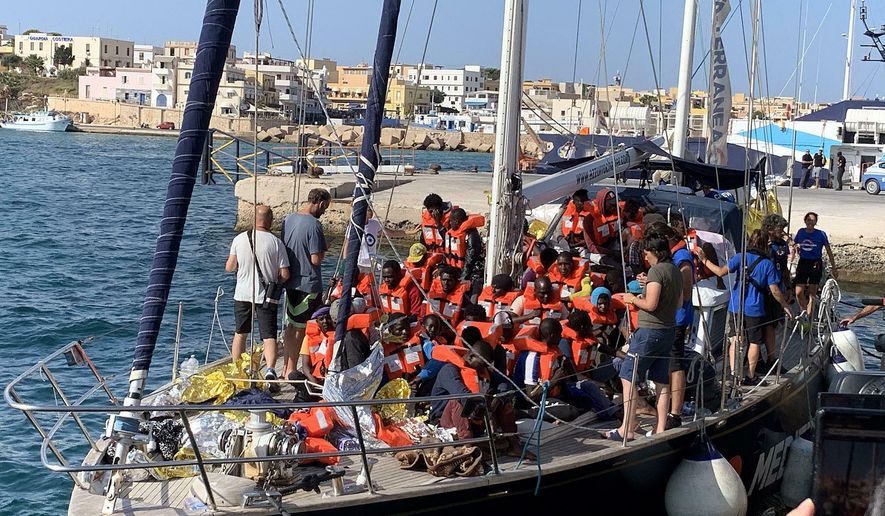 The Italian NGO Mediterranea Saving Humans' Alex migrant rescue ship carrying 46 migrants rescued off Libya coasts, docks in the port of Lampedusa, Sicily island, Italy, Saturday, July 6, 2019. Italy’s hard-line interior minister, Matteo Salvini, has barred all private rescue ships from entering Italian ports. He pointed to an offer from Malta to accept the migrants from the Italian-flagged ship. (Elio Desiderio/ANSA via AP)